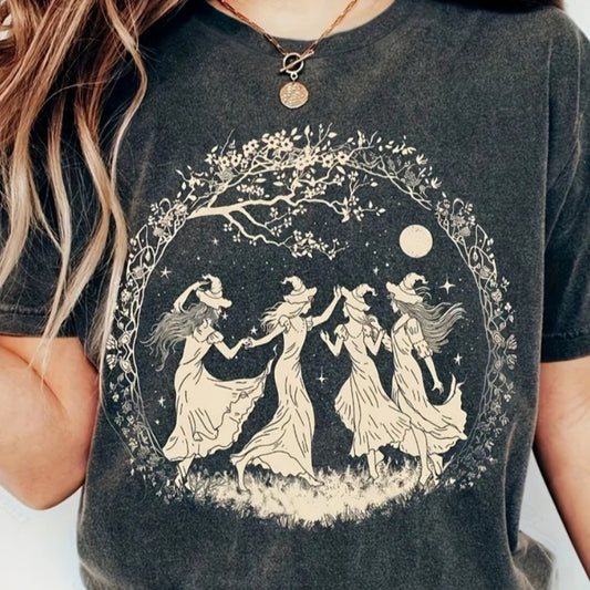 Four witches dancing beneath the moon in a floral circle T-shirt