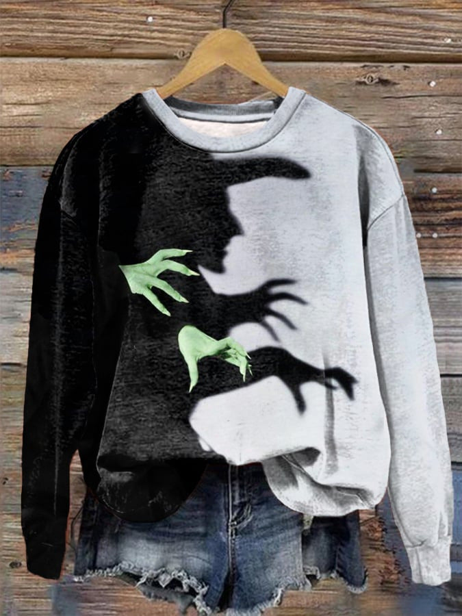 Black and white contrast sweatshirt with witch shadow and green hands