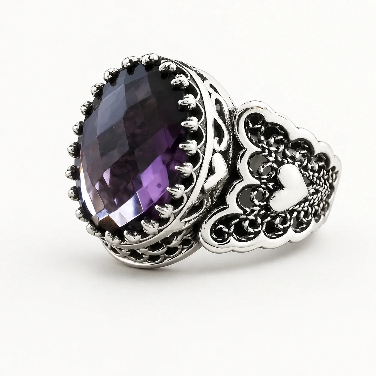 Amethyst Crown Love Ring on a near-white studio background
