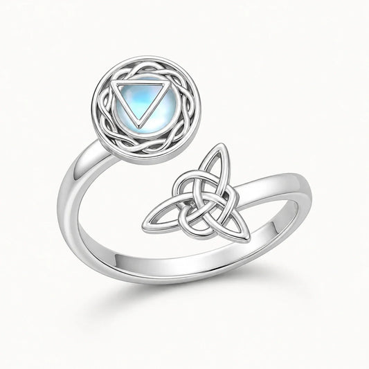 Silver Moonstone Triquetra Spinner Ring on a near-white studio background