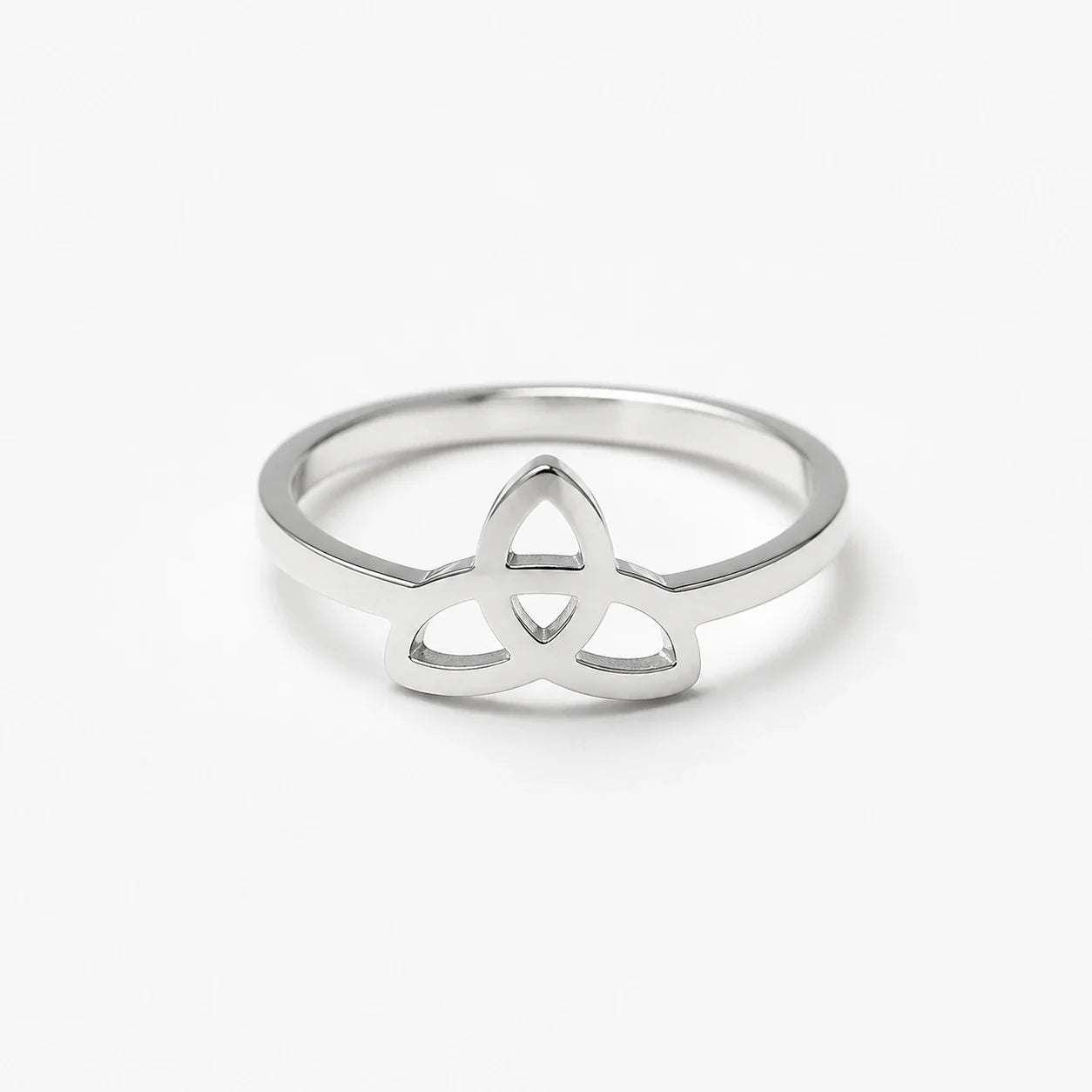 Polished silver Triquetra ring on a near-white studio background