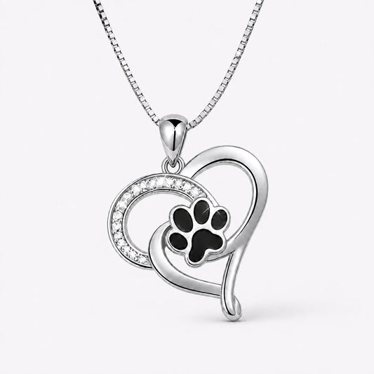 Pawprint Love Necklace with silver heart and black paw on a near-white studio background