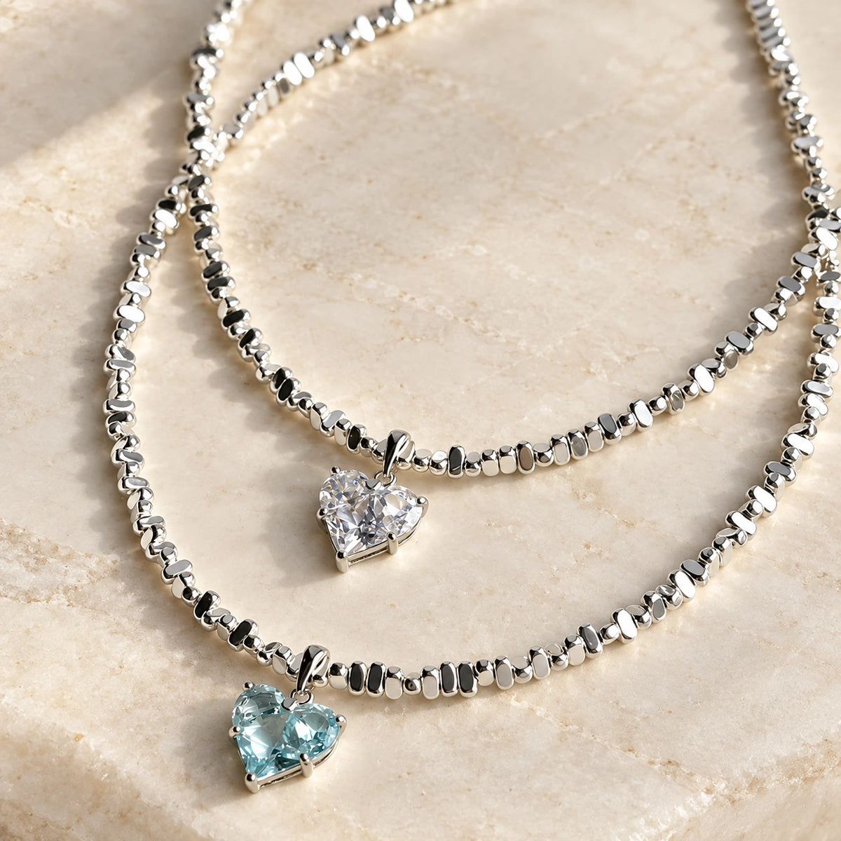 Radiant Love Crystal Necklace clear and aquamarine heart pendants on stone