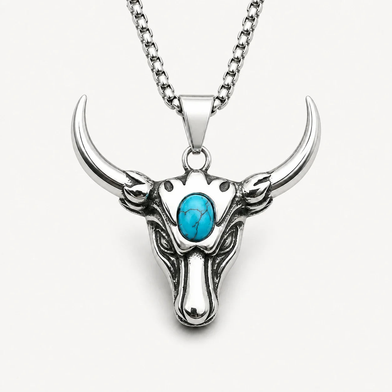 Taurus Guardian Necklace with turquoise accent on a warm white studio background